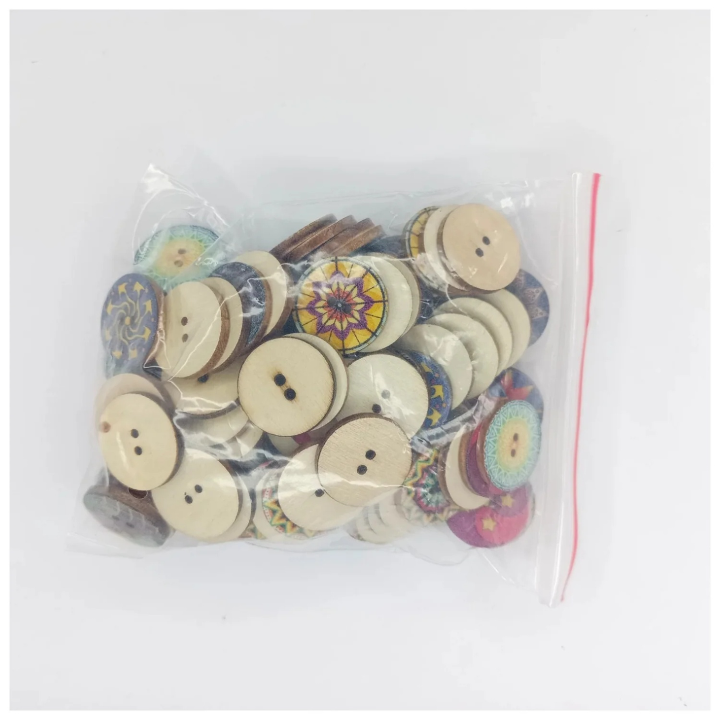 Bag of assorted buttons with colorful designs on a white background
