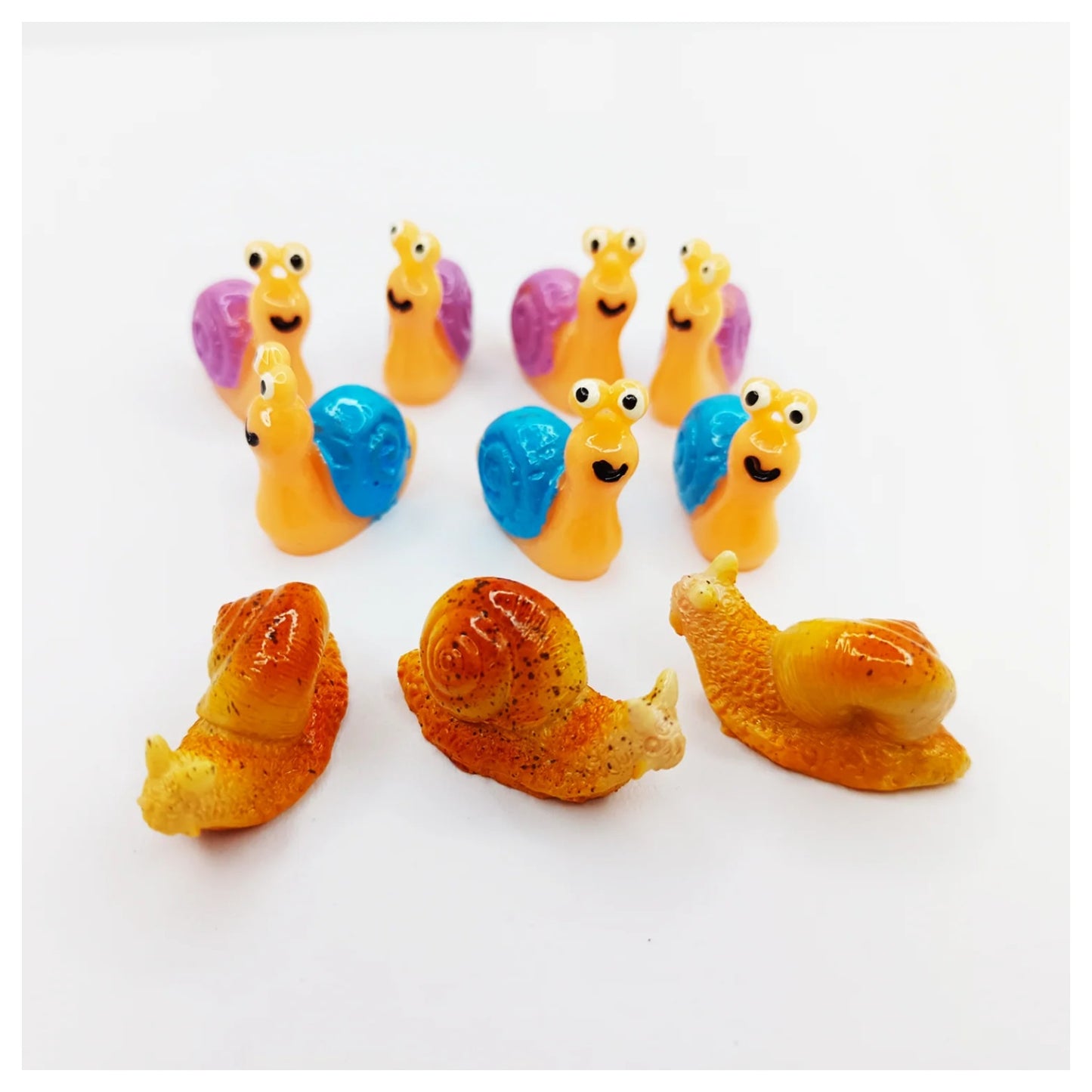 Colorful snail figurines on a white background