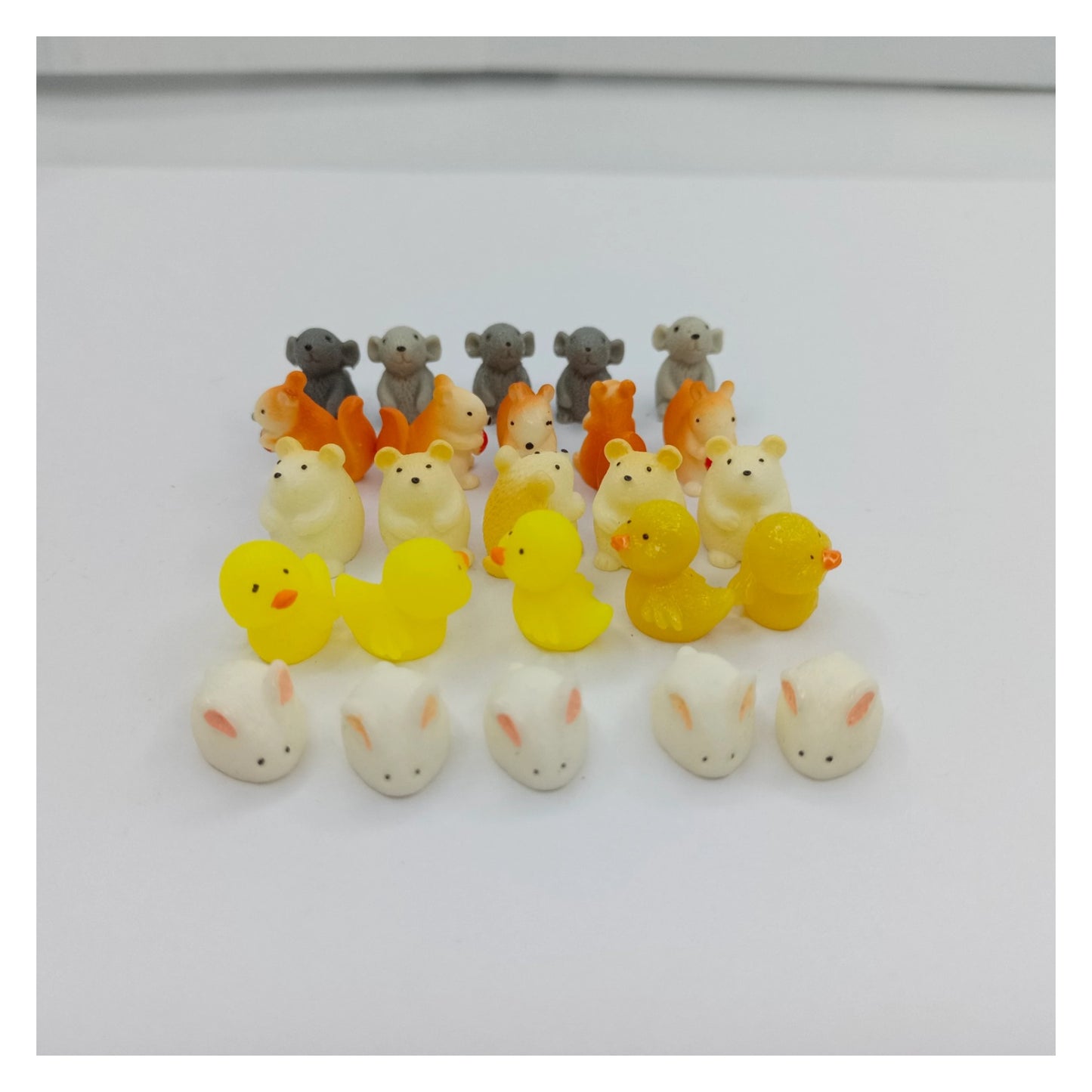 Collection of small animal figurines on a white background