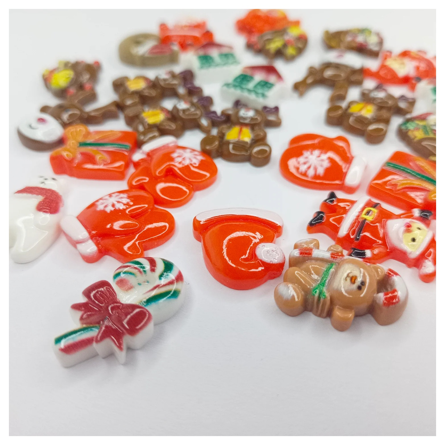 Assorted Christmas-themed cabochons on a white background