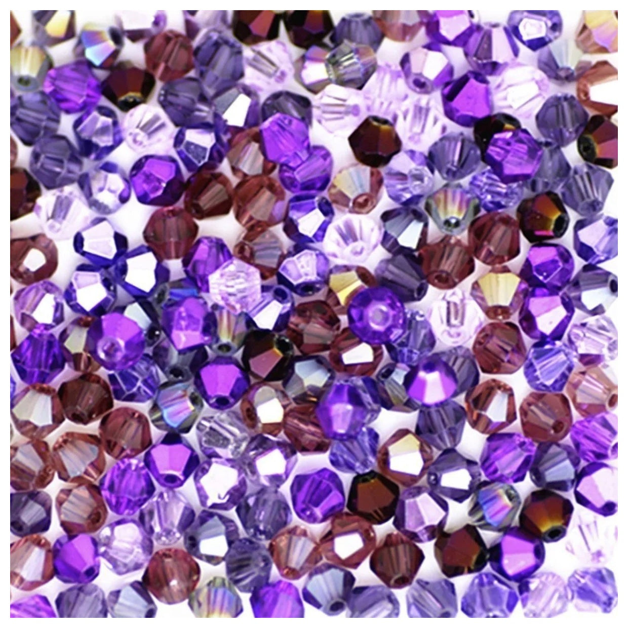 Assorted purple and brown beads on a white background