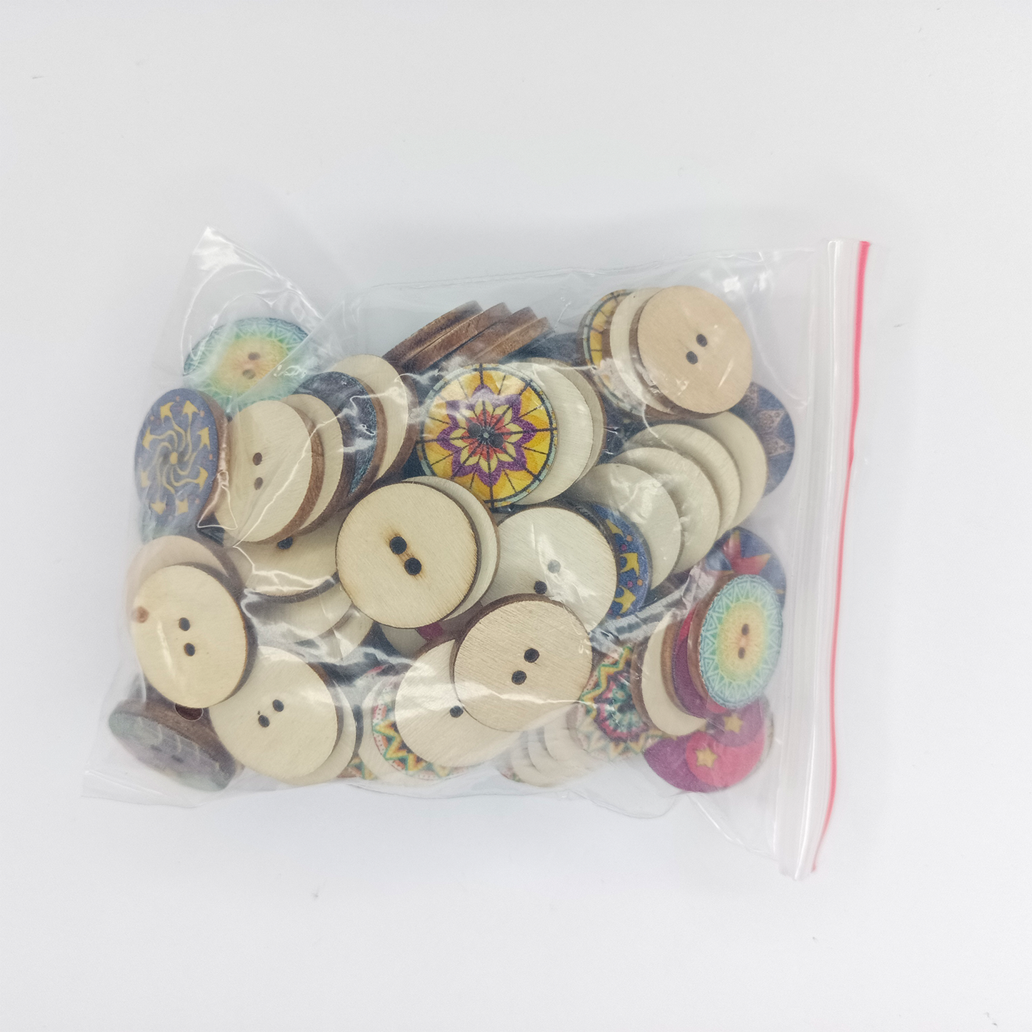 Bag of assorted buttons with colorful designs on a white background