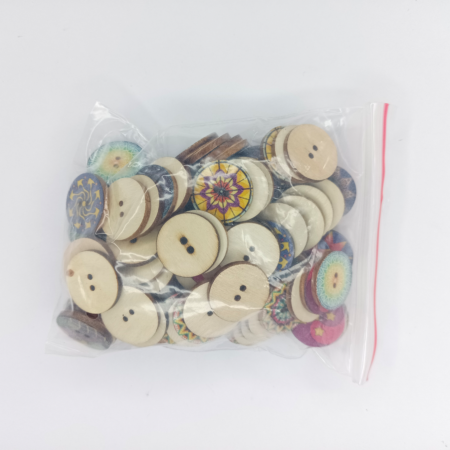 Bag of wooden buttons with colorful designs on a white background