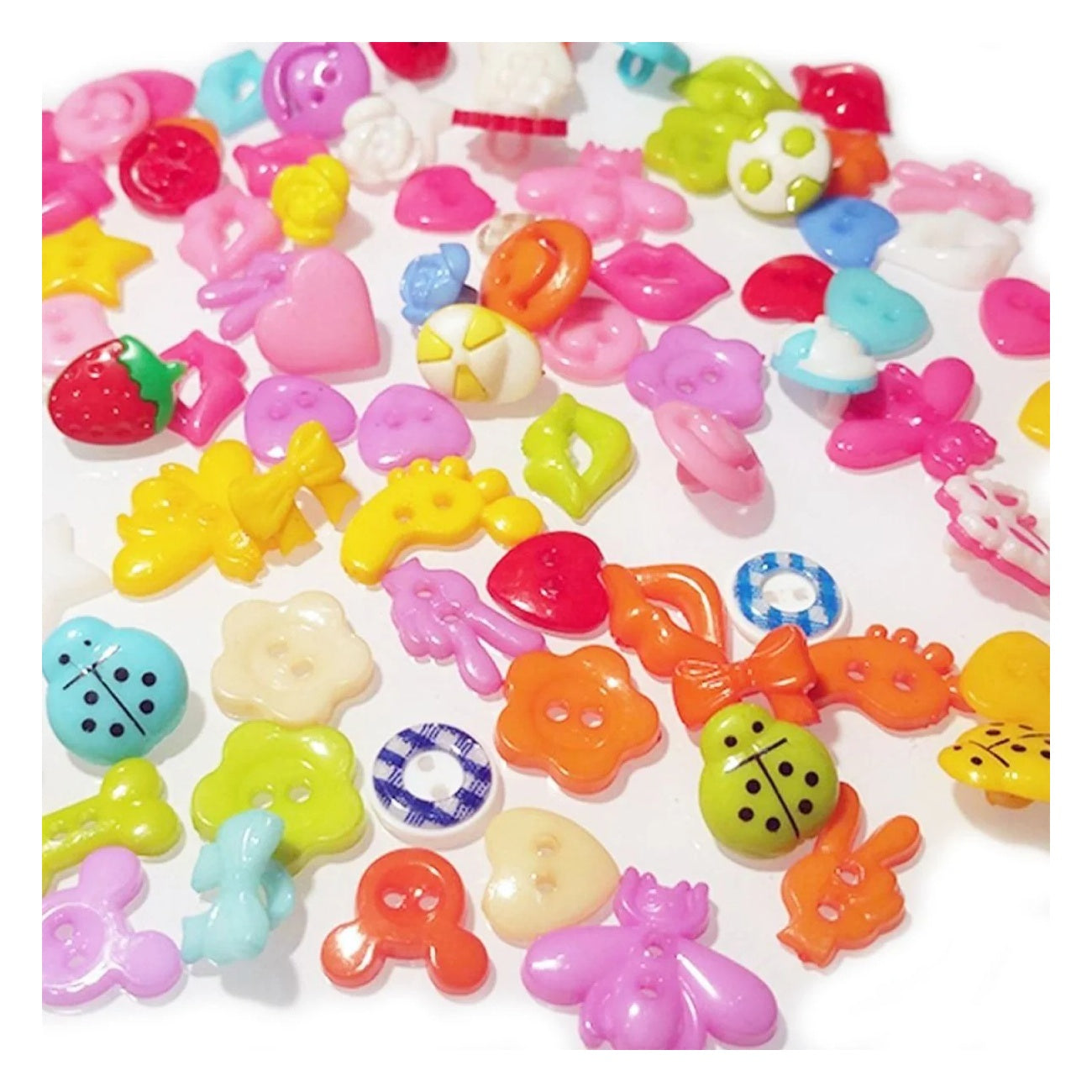 Assorted colorful plastic buttons on a white background