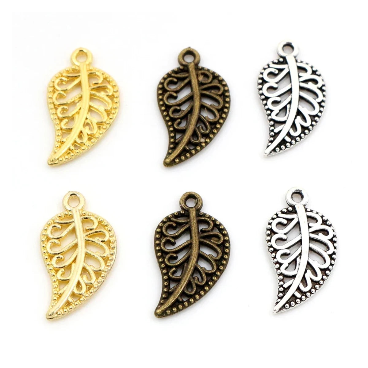 A collection of leaf-shaped charms in gold and silver colors with intricate patterns, intended for use in crafting jewelry such as bracelets and necklaces.