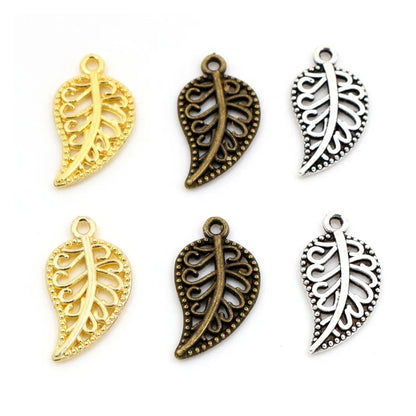 A collection of leaf-shaped charms in gold and silver colors with intricate patterns, intended for use in crafting jewelry such as bracelets and necklaces.