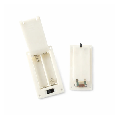 Two white battery holders 2xaaa with tabs and switch and lid on a white background