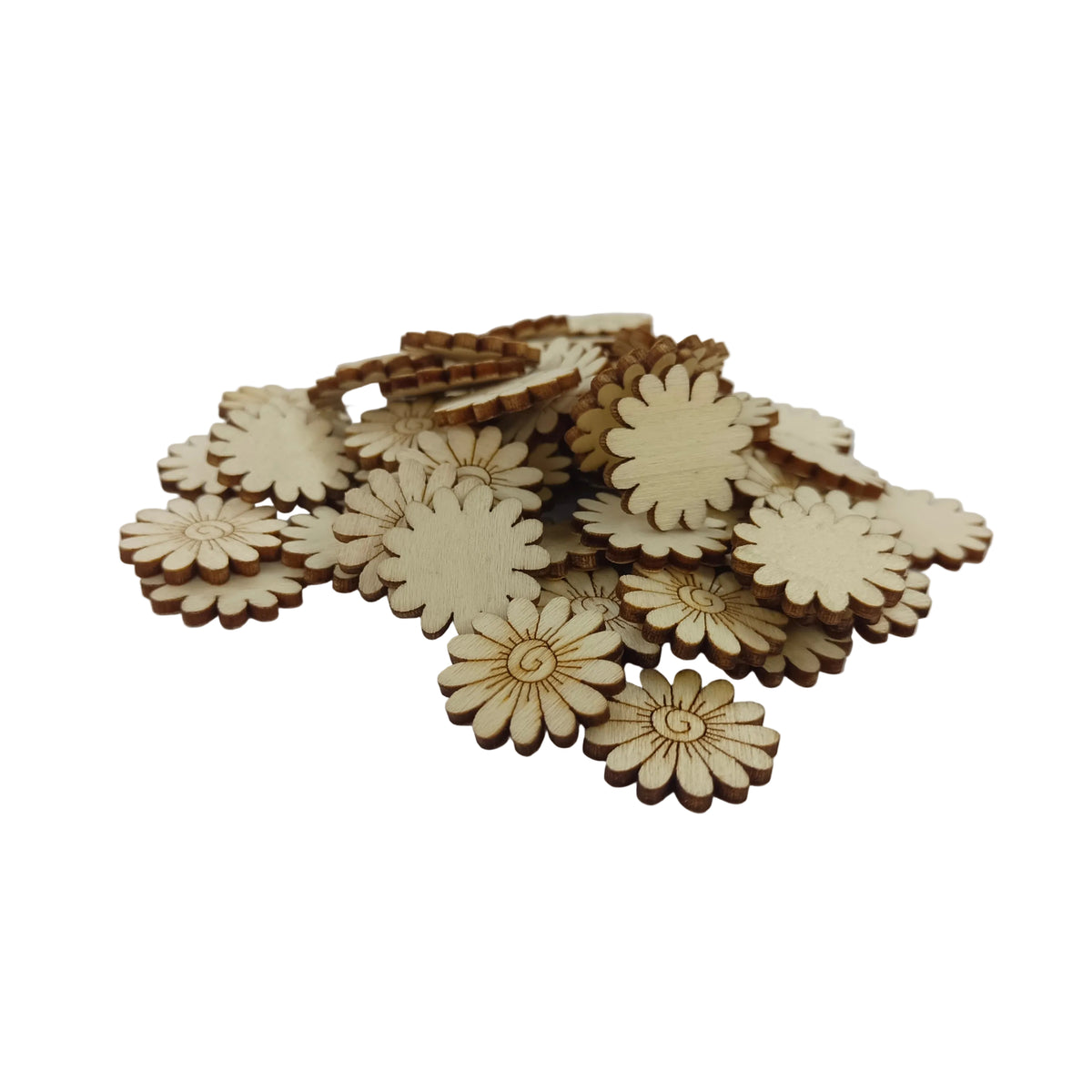 A pile of small laser-cut wooden daisy-shaped embellishments on a plain white surface.