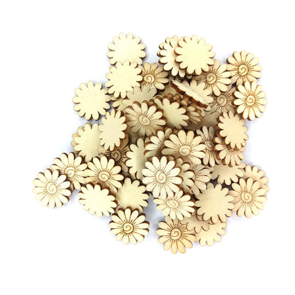 A pile of small natural wood daisy-shaped craft embellishments on a plain light gray background.