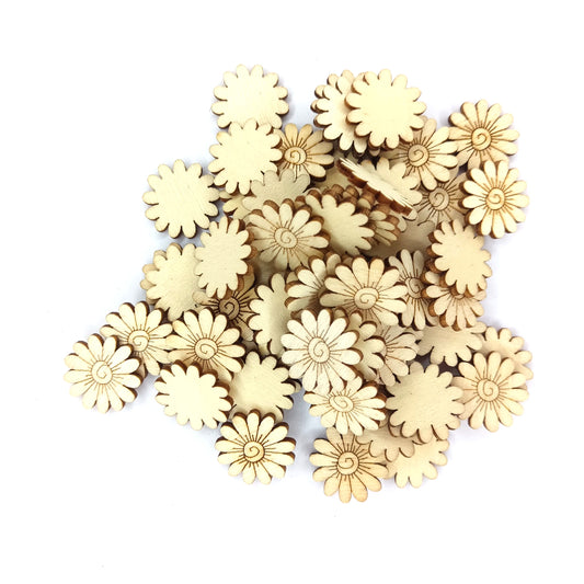 A pile of small natural wood daisy-shaped craft embellishments on a plain light gray background.