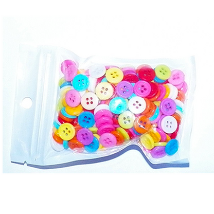 Assorted colorful buttons in a clear plastic bag on a white background
