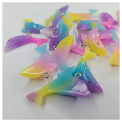 Colorful dolphin-shaped charms on a white background