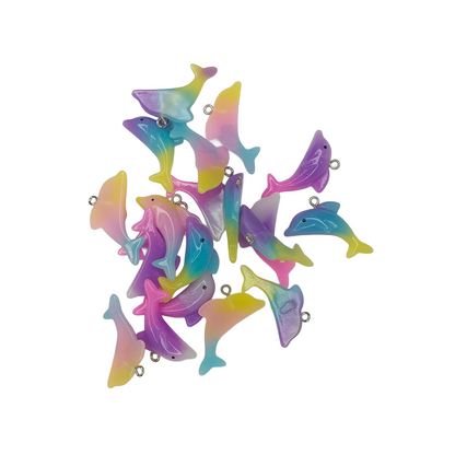 Colorful dolphin-shaped charms on a white background