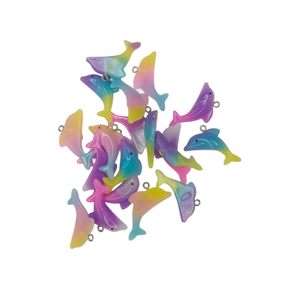 Colorful dolphin-shaped charms on a white background