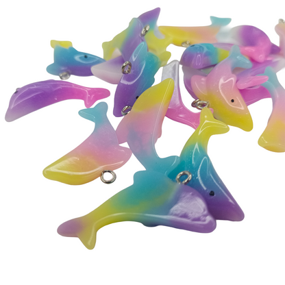 Colorful dolphin-shaped toys on a white background
