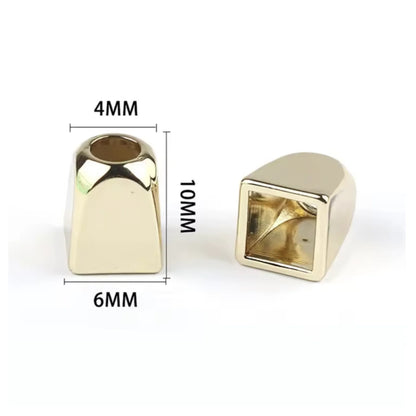 Two gold coloured metal rope pull ends with measurements on a white background