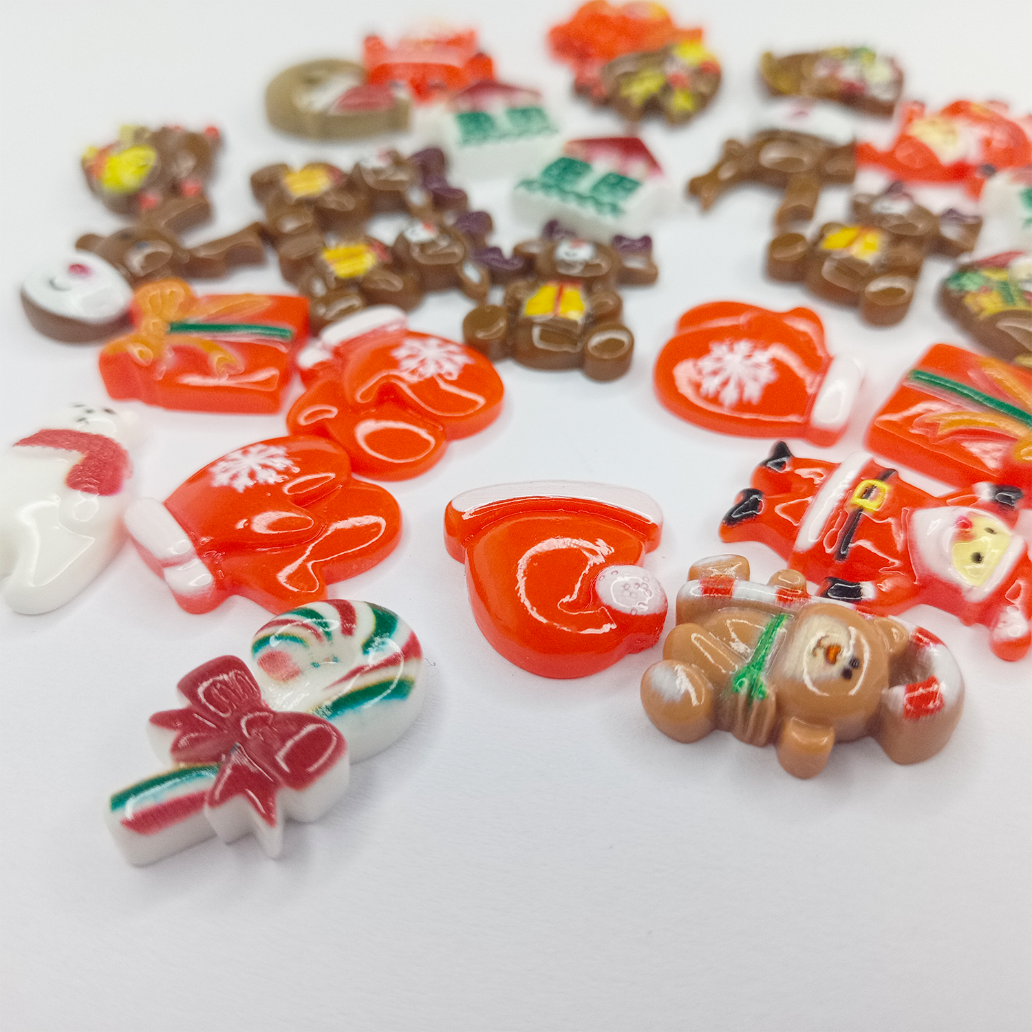 Assorted Christmas-themed cabochons on a white background