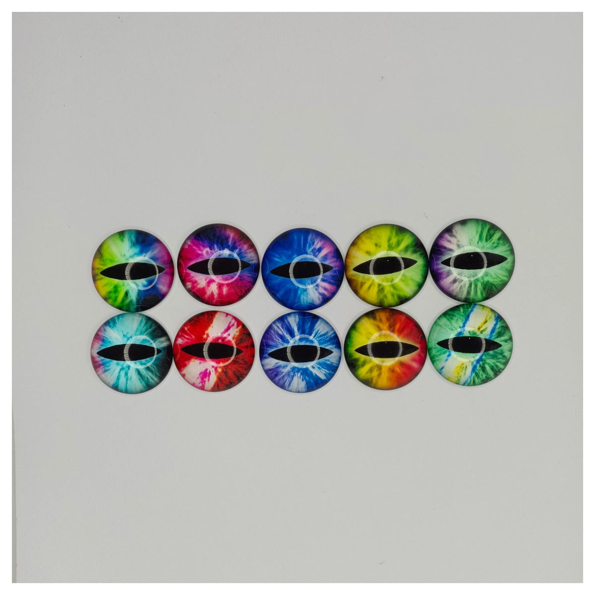 Colorful tie-dye eye-shaped buttons on a white background