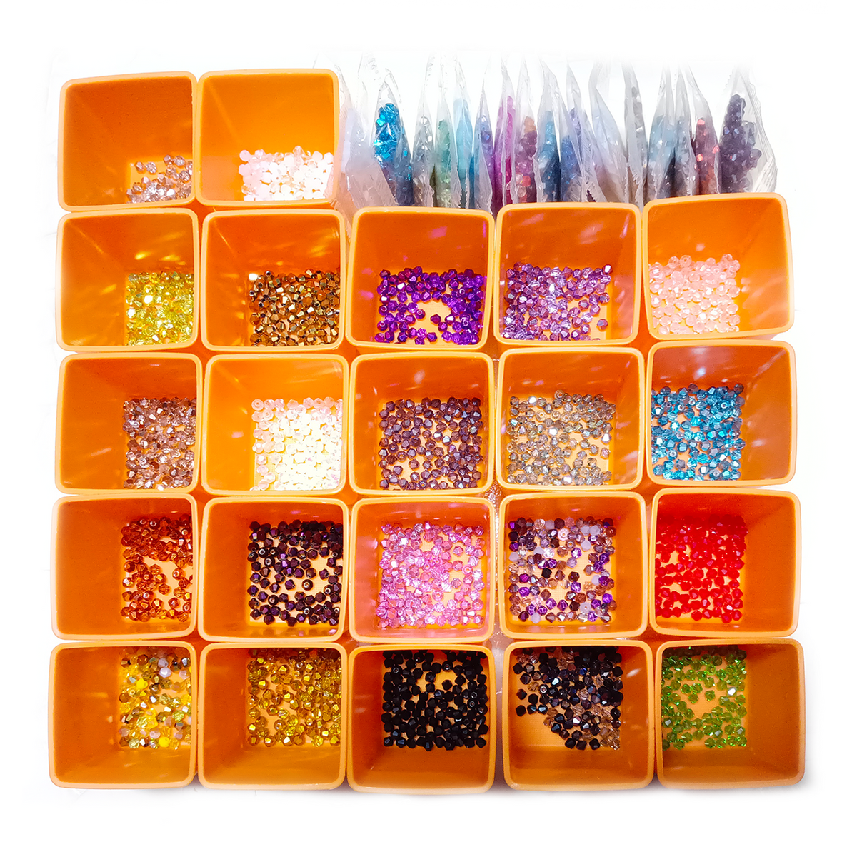 Orange container with compartments filled with various colored beads and sequins on a white background