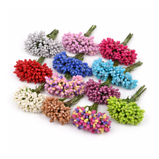 Assorted colorful artificial mulberry flowers on a white background