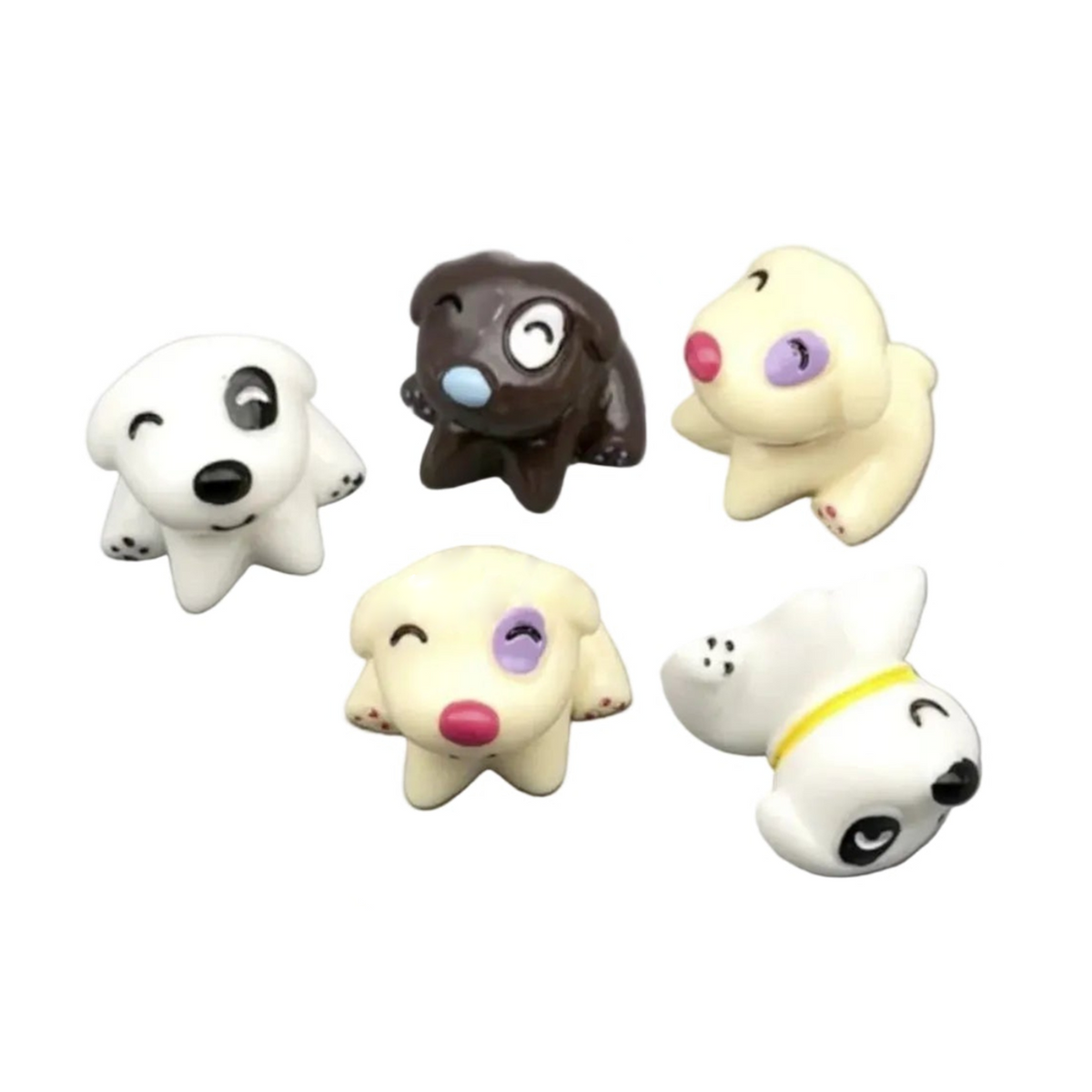 Five small animal-shaped charms or beads arranged on a plain white background. The designs include black-and-white, dark brown, cream, and white animals with simple facial features and small accent colors.
