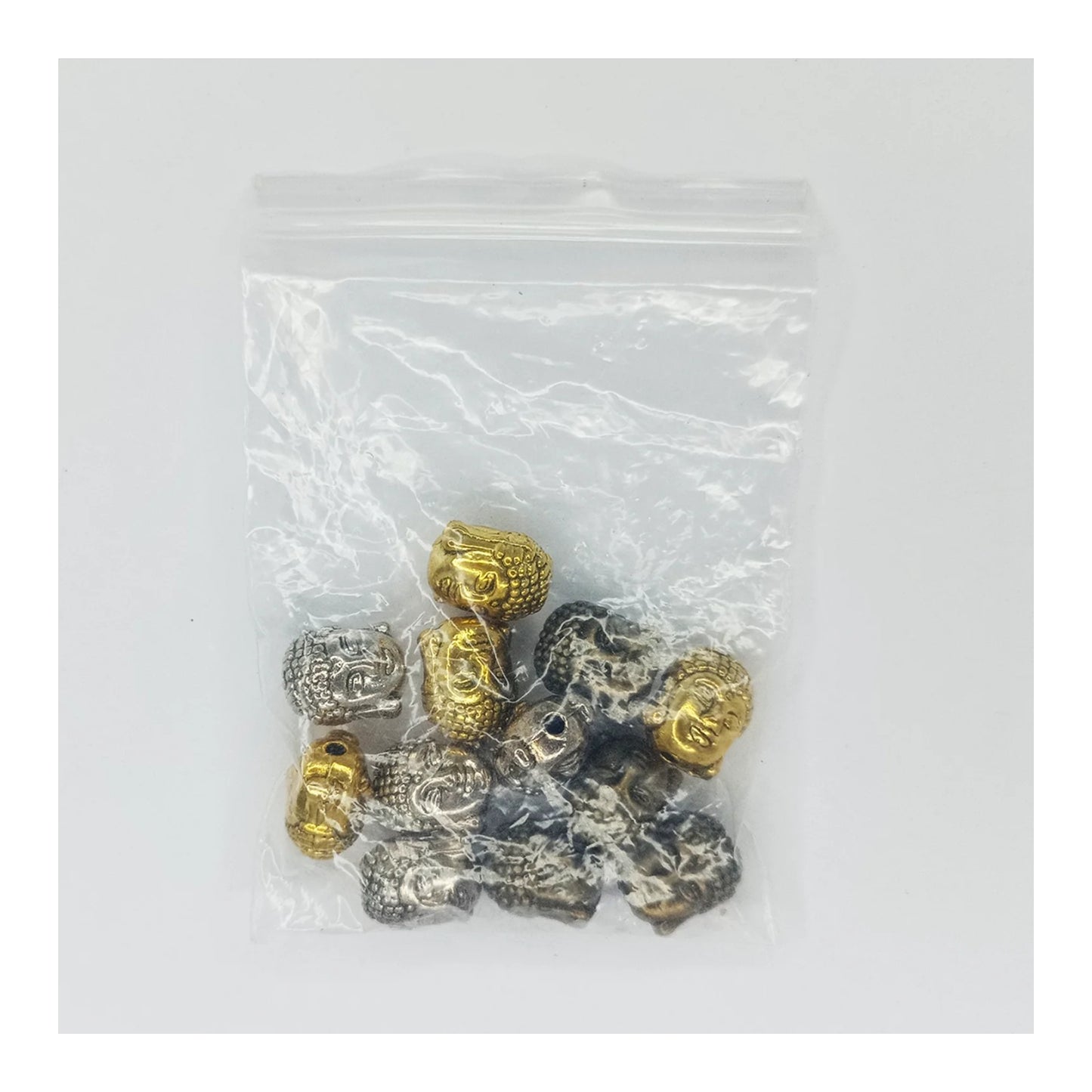 Bag of gold and silver beads on a white background