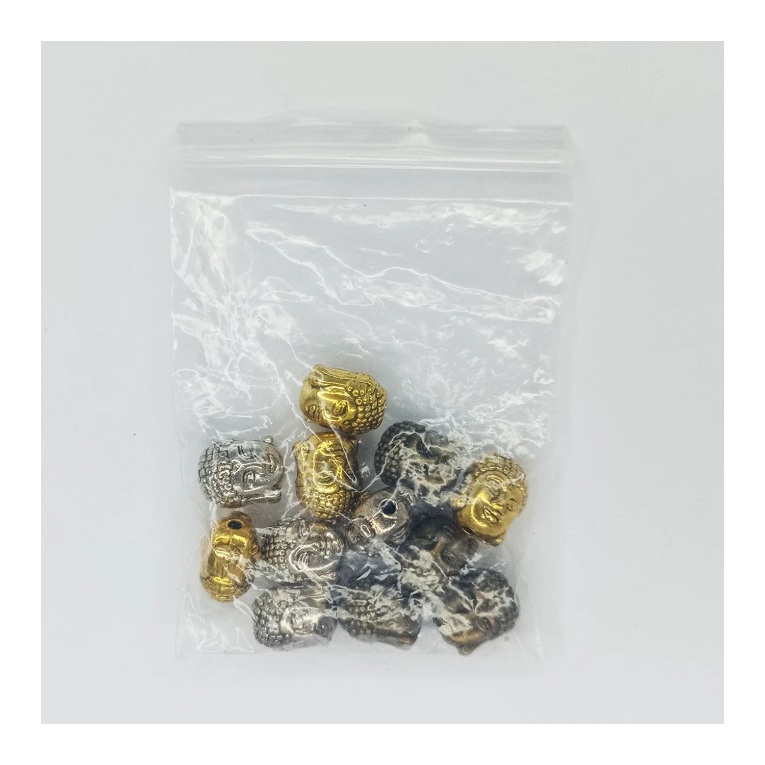 Bag of gold and silver beads on a white background