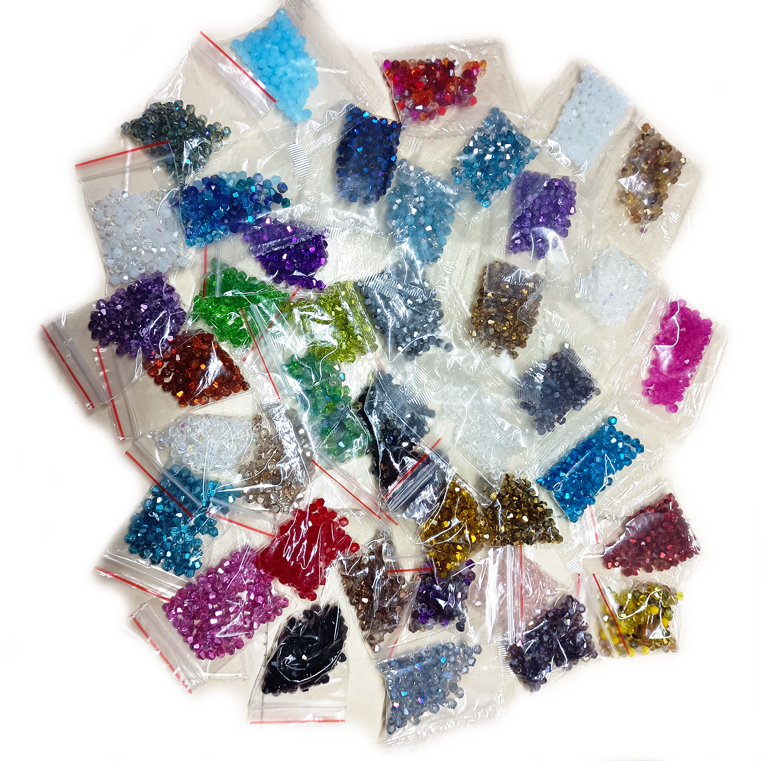 Assorted colored crystals in small clear bags on a white background