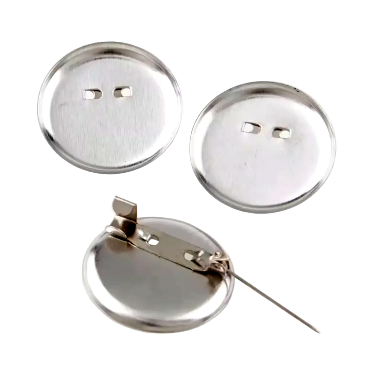 Several small round metallic pin-back cabochon holders, mostly shown from the back on a light gray background. The buttons have silver-toned metal backs.