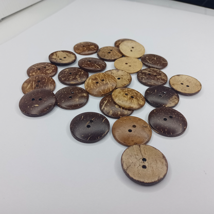 Collection of brown and beige buttons on a white surface