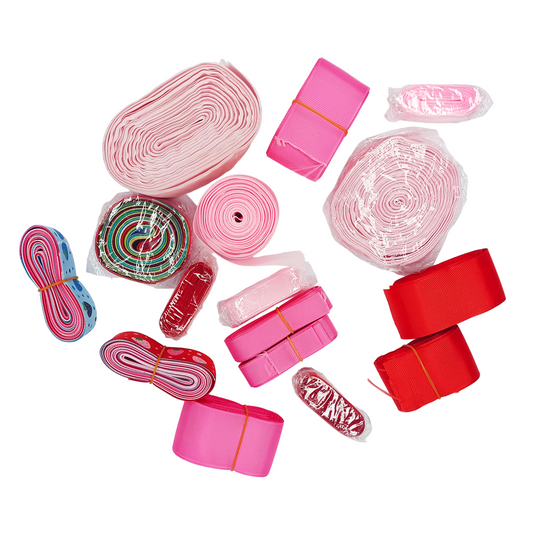 Collection of pink and red ribbons on a white background