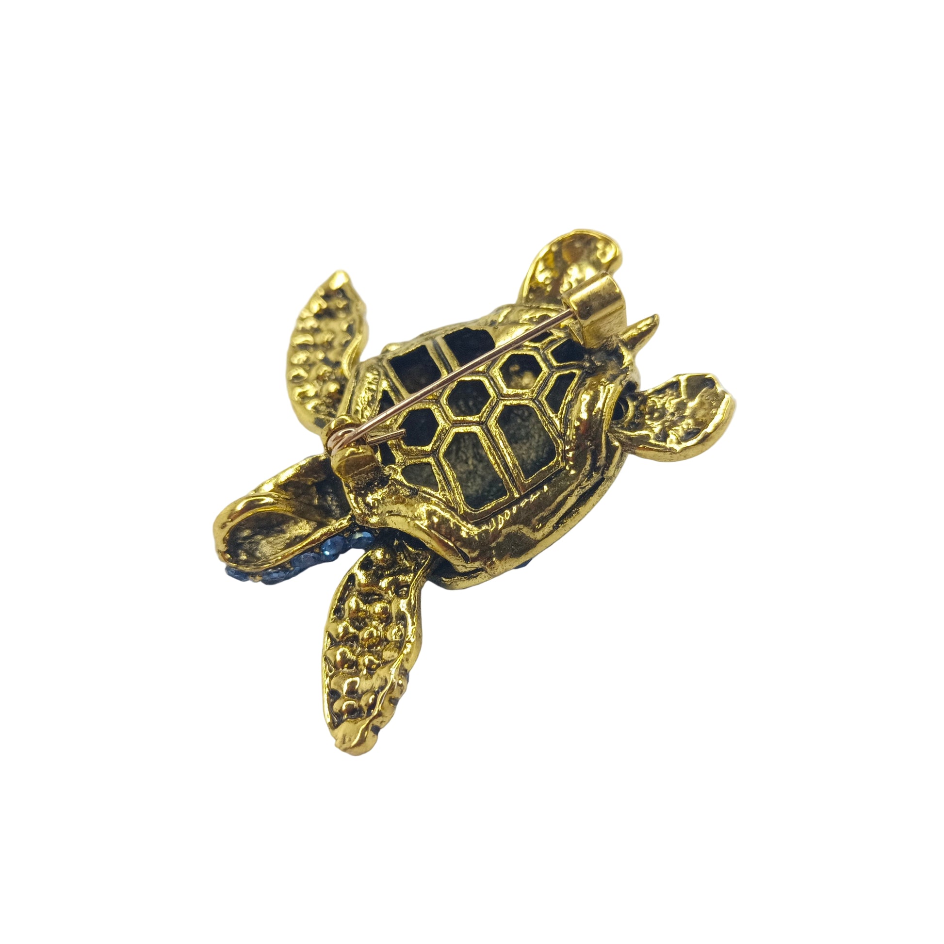 Gold turtle-shaped brooch back side showing pin on a white background