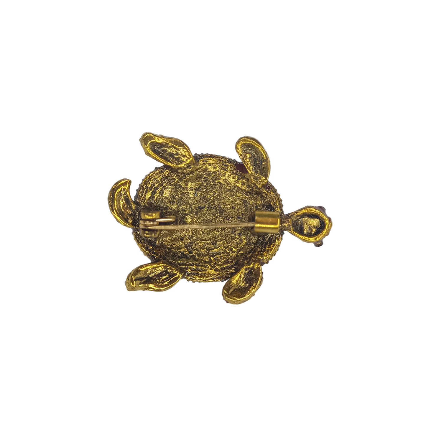 Gold turtle-shaped brooch on a gray background