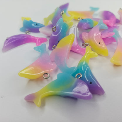 Colorful dolphin-shaped charms on a white background
