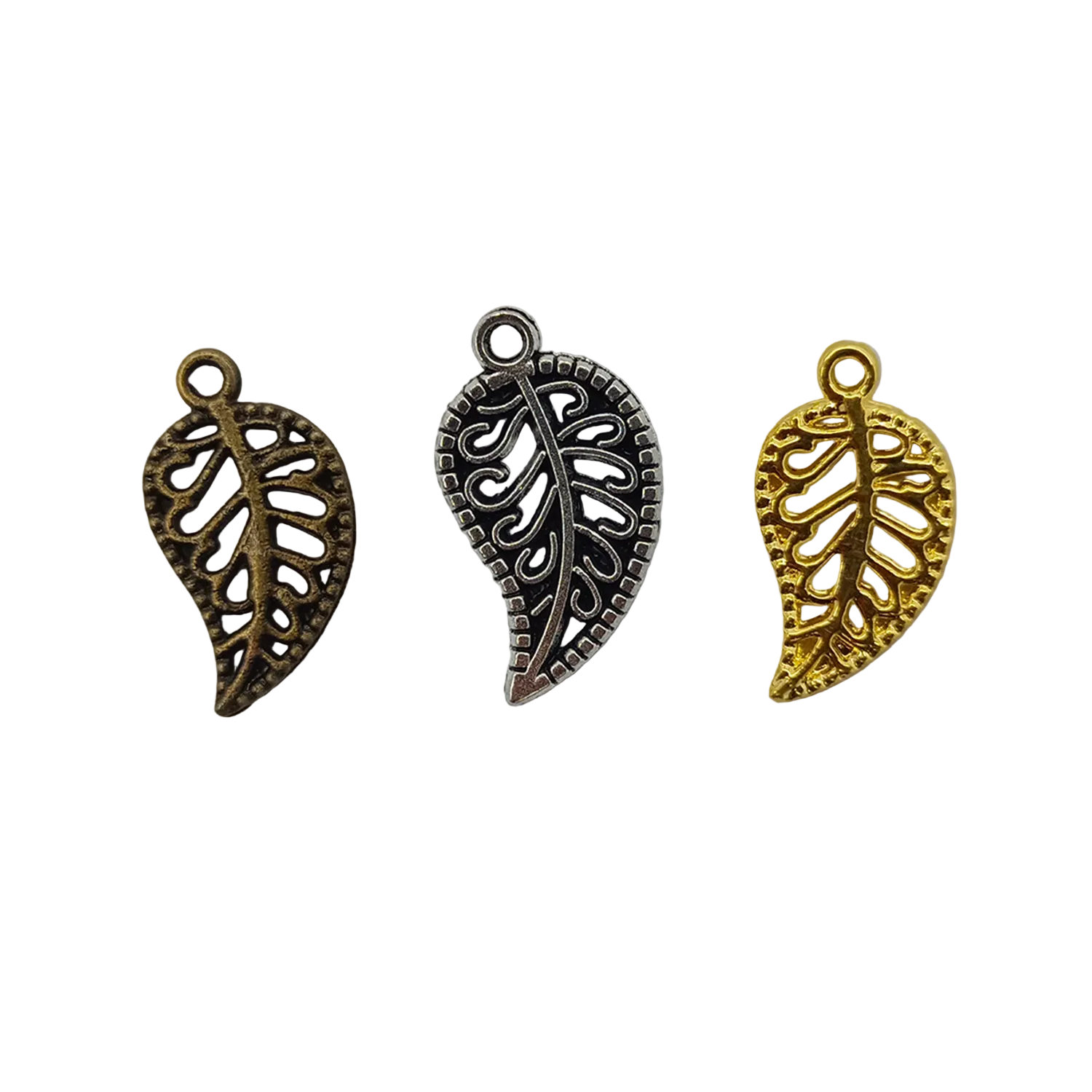 Three leaf-shaped metal charms in bronze, silver, and gold on a light gray background.