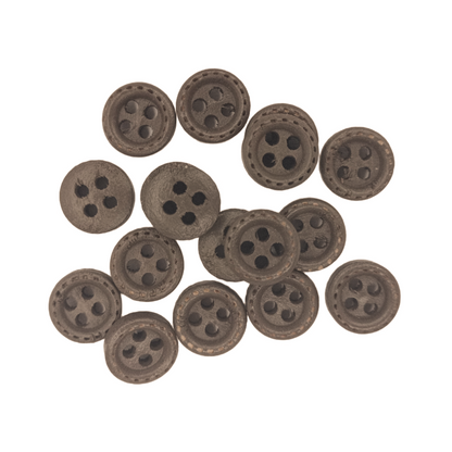 Set of brown buttons with four holes on a white background