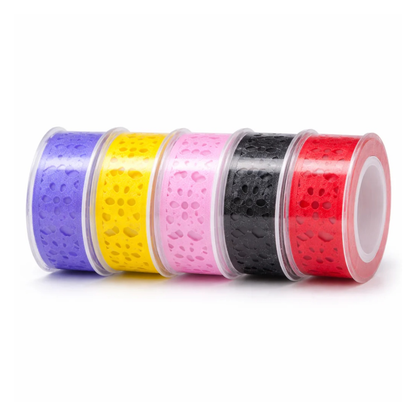 Five rolls of colorful tape with cutout patterns surface in clear containers on a white background