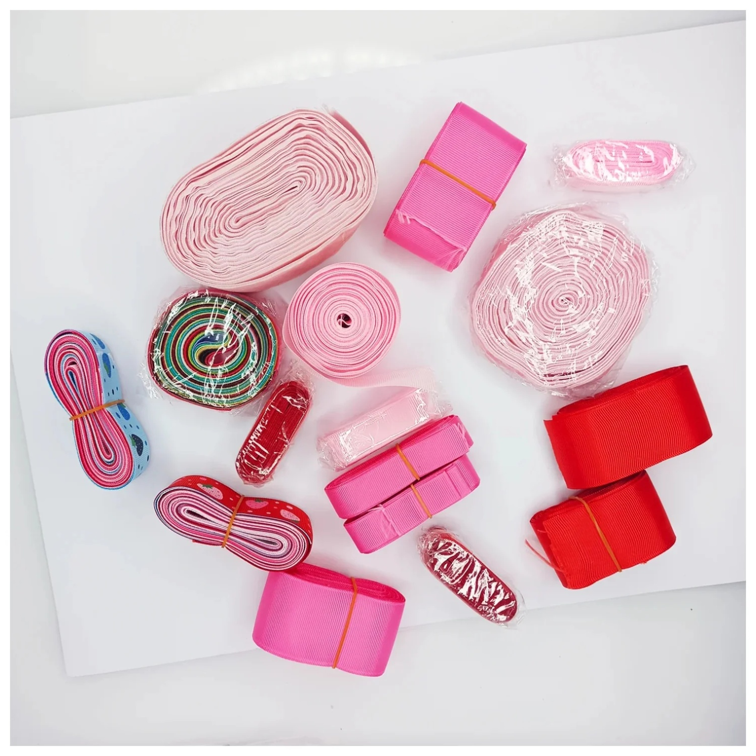 Collection of pink and red ribbons on a white background